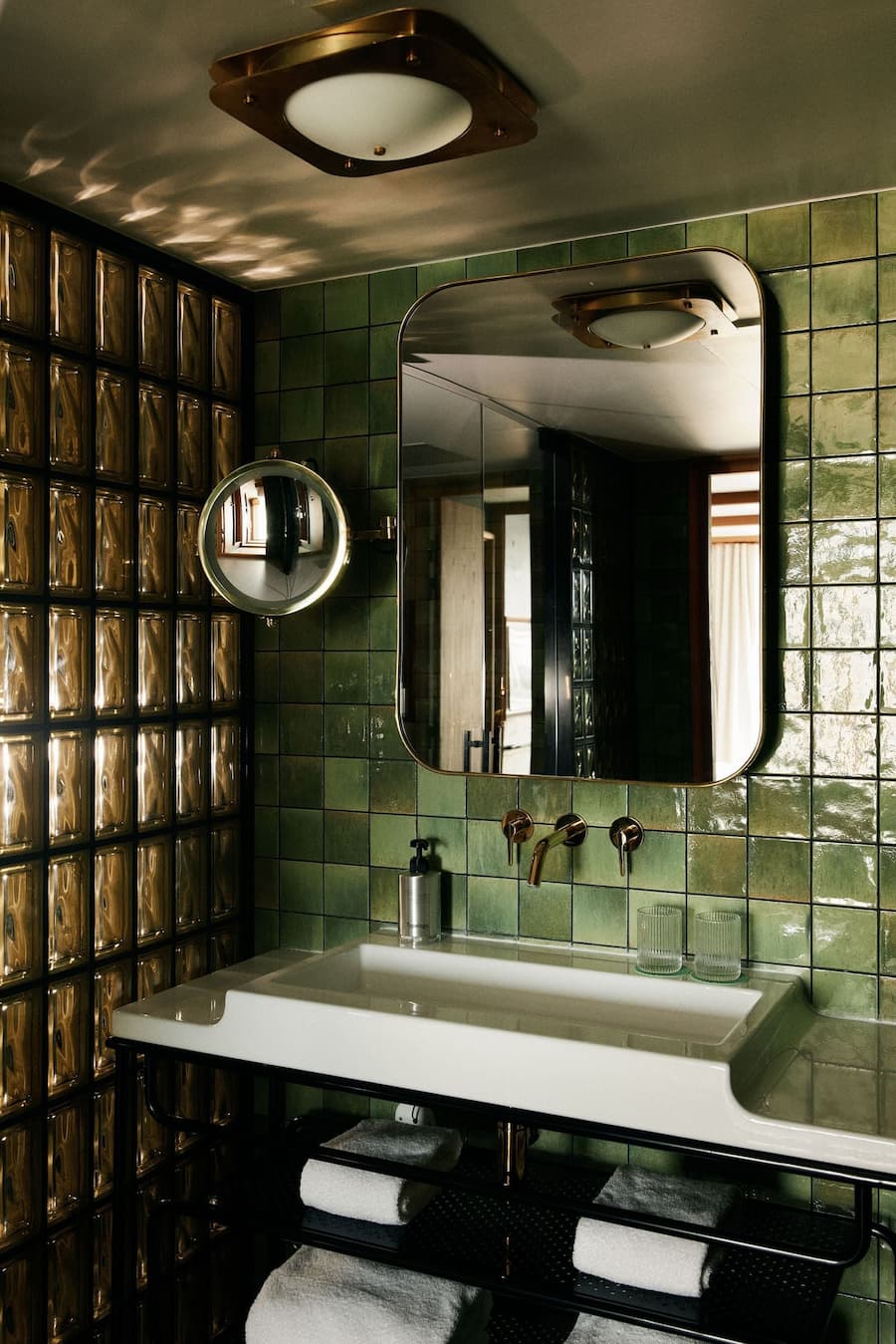 Green tiled bathroom interior at La Fondation Paris hotel