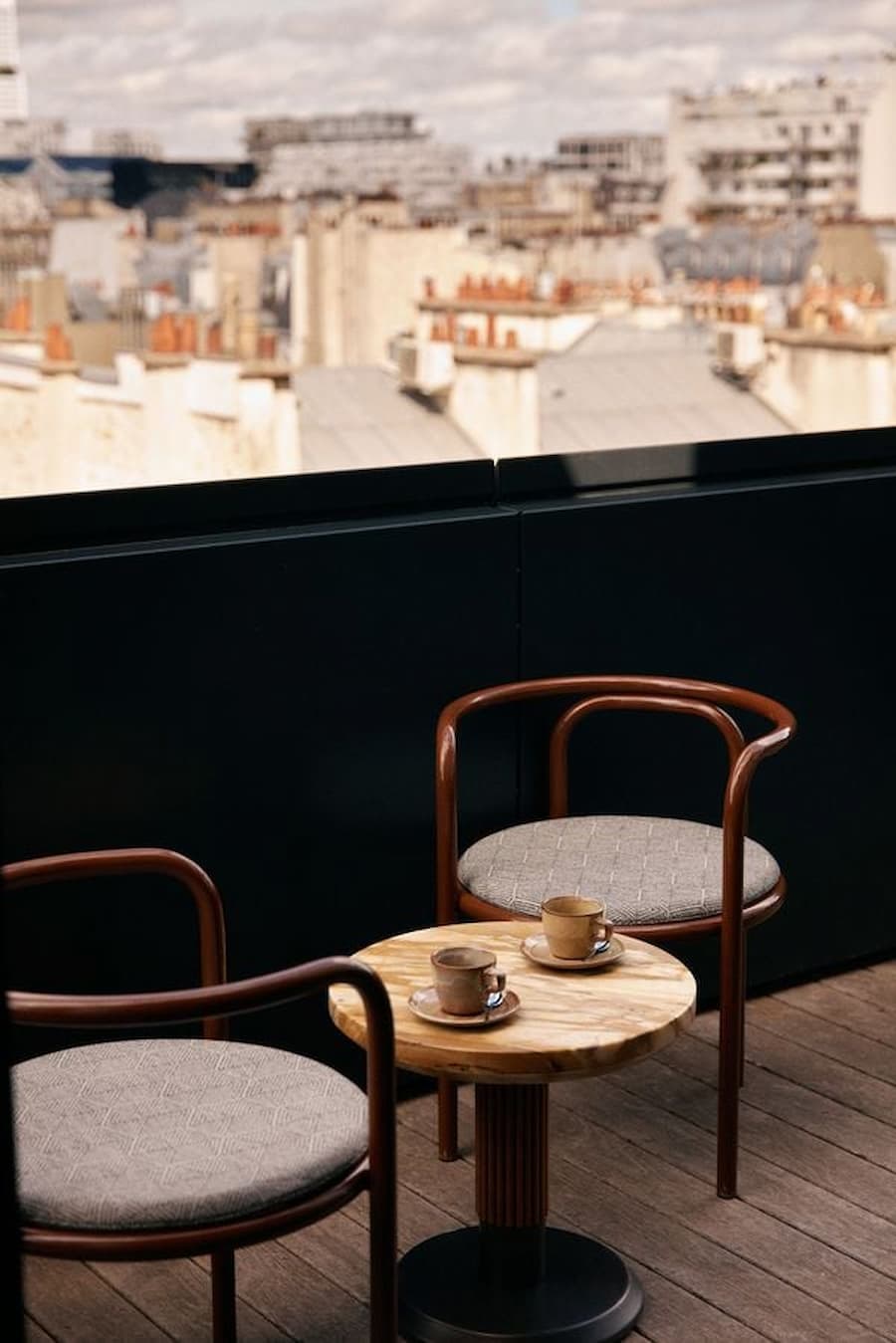 Balcony seating with Paris rooftop city view at La Fondation