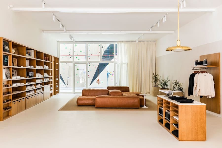 Contemporary retail space featuring natural materials, custom shelving and soft neutral tones