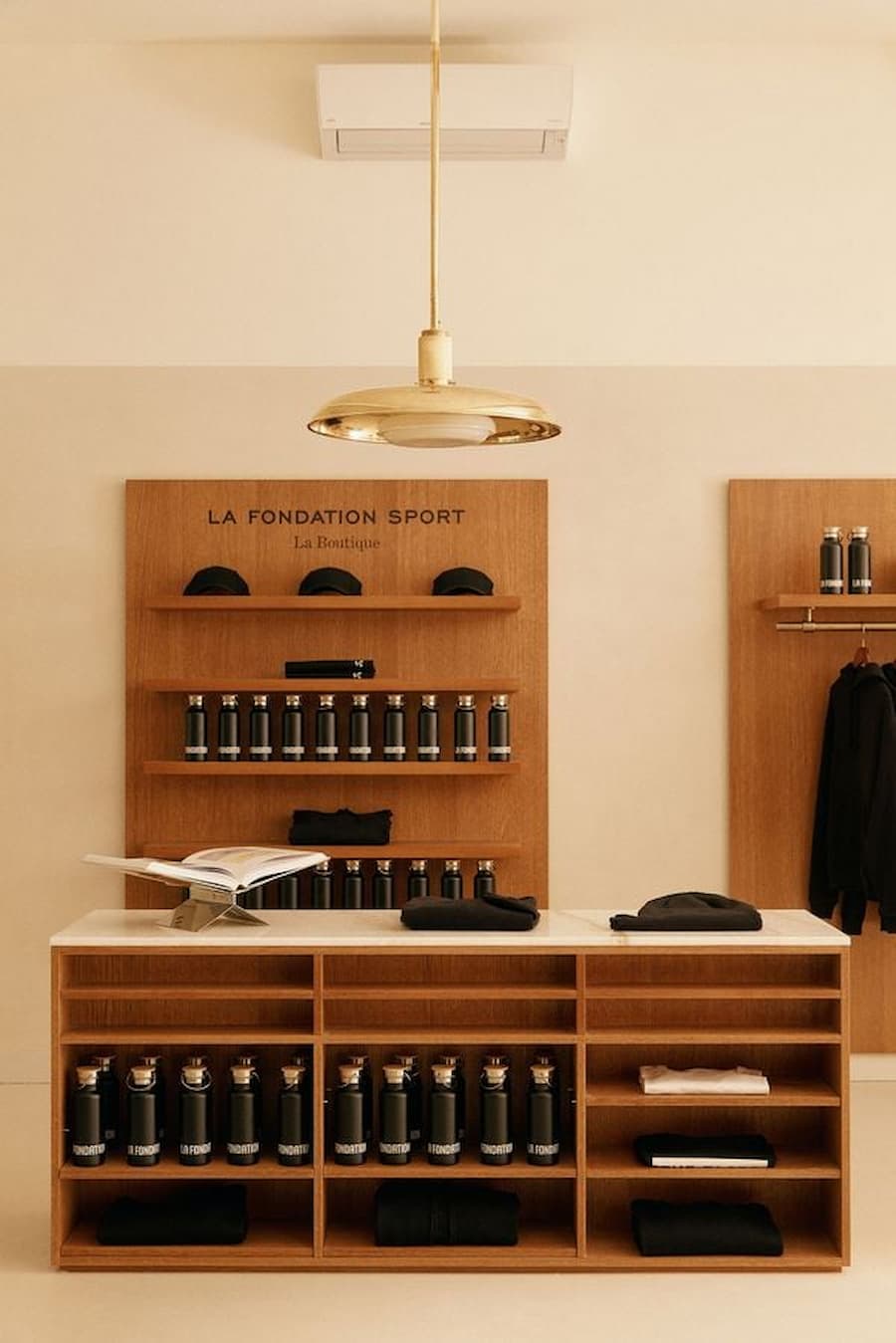 Boutique retail display with custom wood shelving, sportswear products and minimalist styling