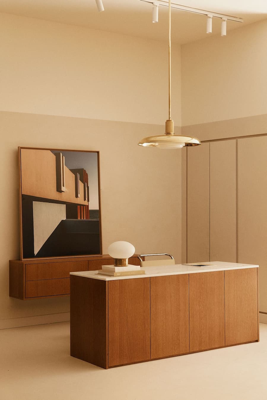 Modern boutique reception counter with natural wood cabinetry and soft neutral palette