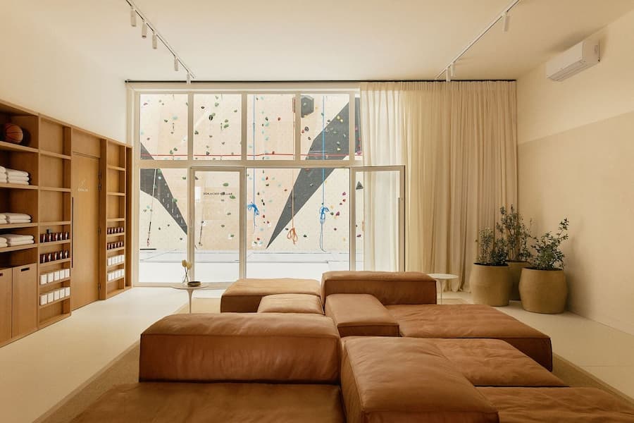 Luxury wellness lounge with modular leather seating and calming natural material palette