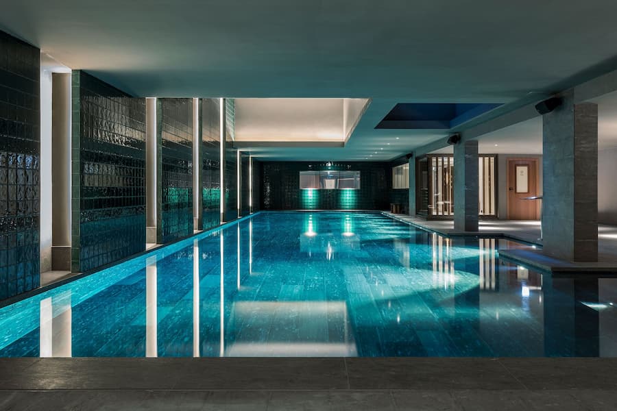 Luxury indoor spa pool with ambient lighting and reflective water surfaces