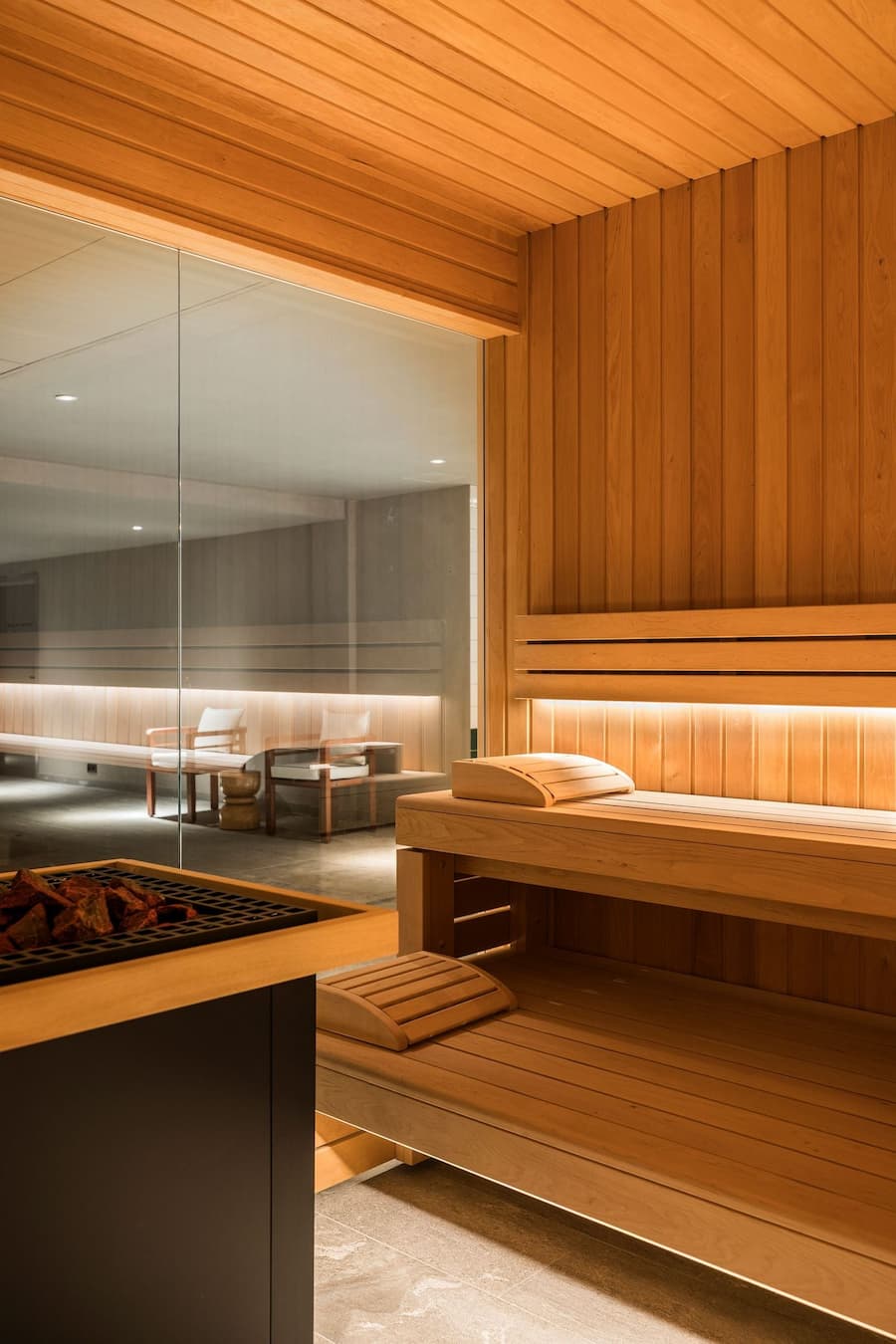 Minimal wood sauna interior with warm lighting and integrated bench seating