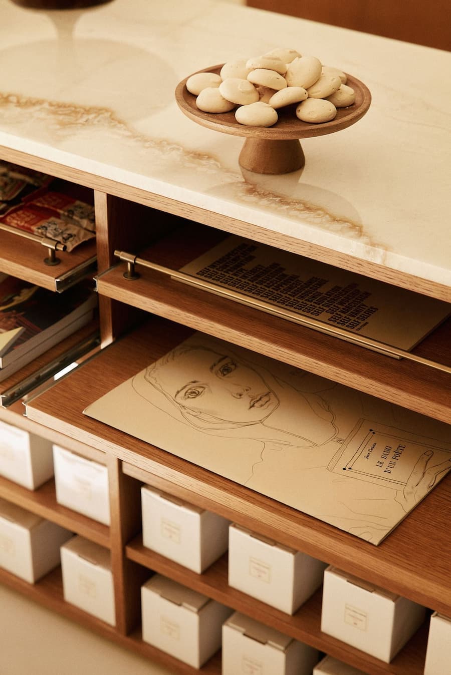 Marble retail display detail with integrated shelving and curated objects