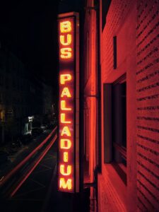 Historic Bus Palladium neon sign on the Paris hotel facade at night by Studio KO