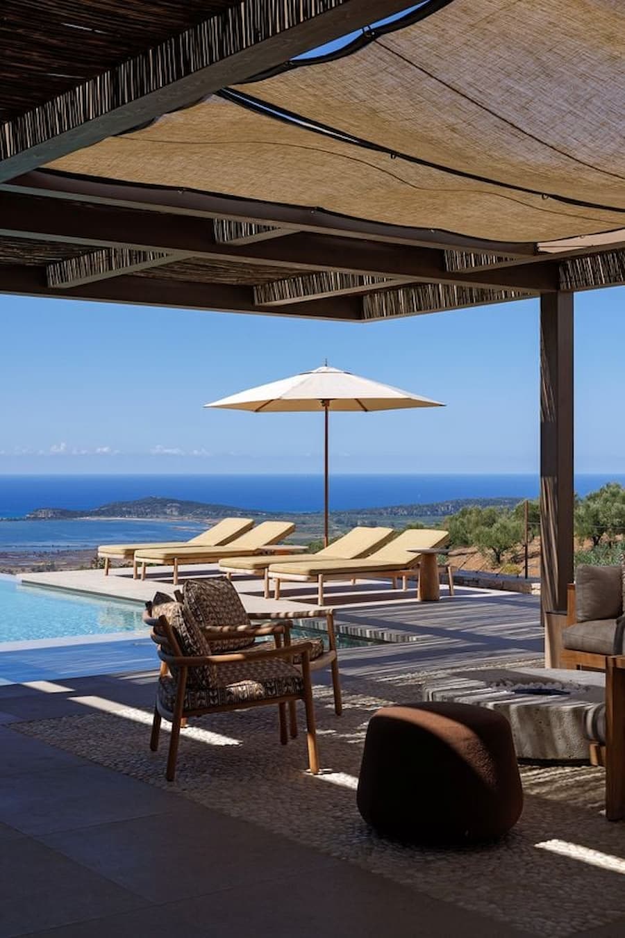 Covered outdoor lounge and infinity pool overlooking Navarino Bay in Messinia