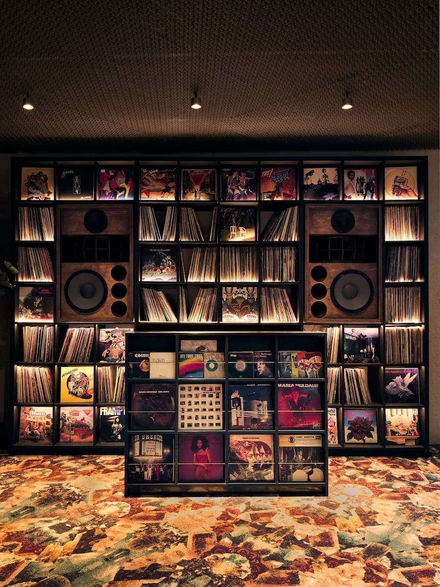 Vintage vinyl record collection and custom speakers inside Bus Palladium Hotel Paris