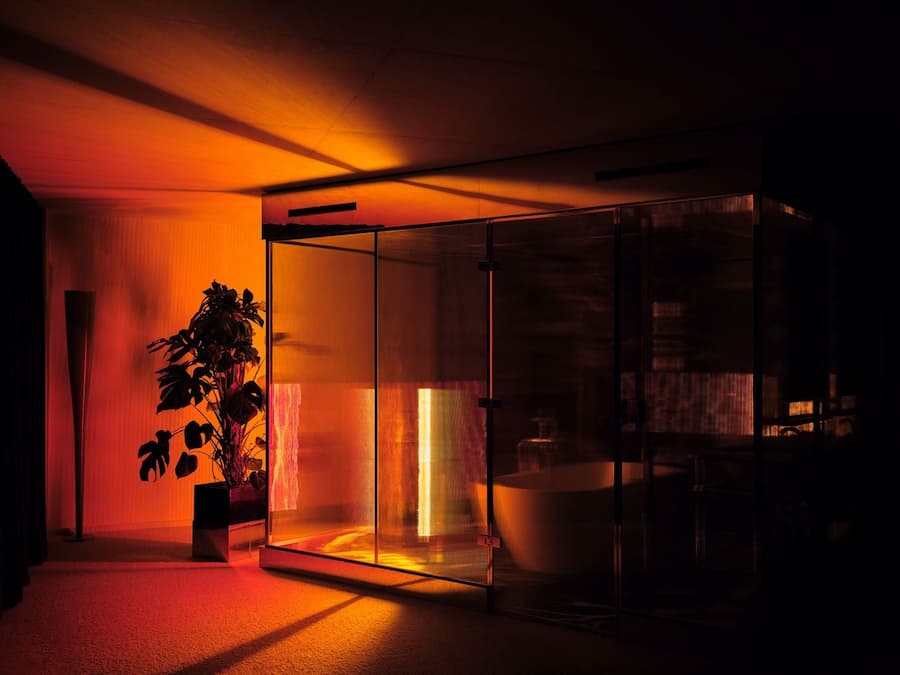 Warm glowing glass bathroom inside Bus Palladium Hotel Paris designed by Studio KO