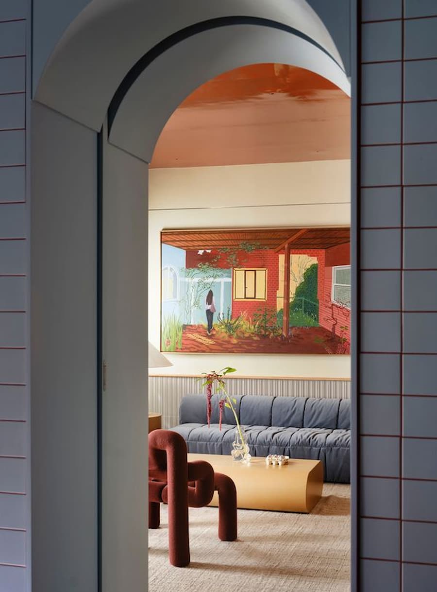 Arched doorway framing the colorful living room inside the renovated Madrid residence.