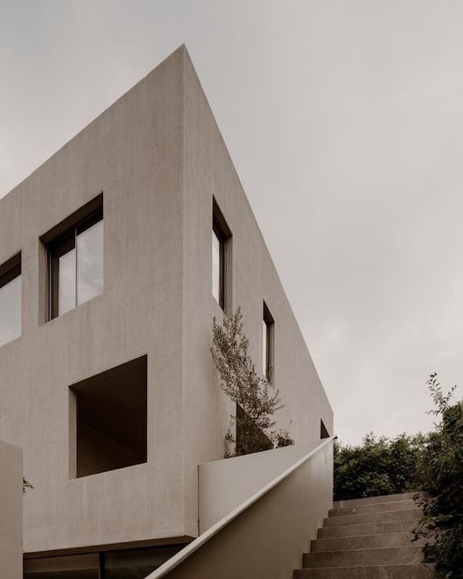 Upper plaster facade of Barrancas House overlooking the landscaped approach