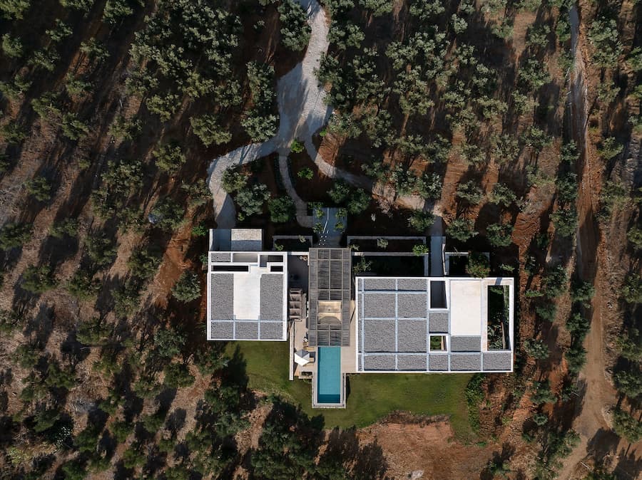 Top view revealing the villa's courtyard composition within the olive landscape