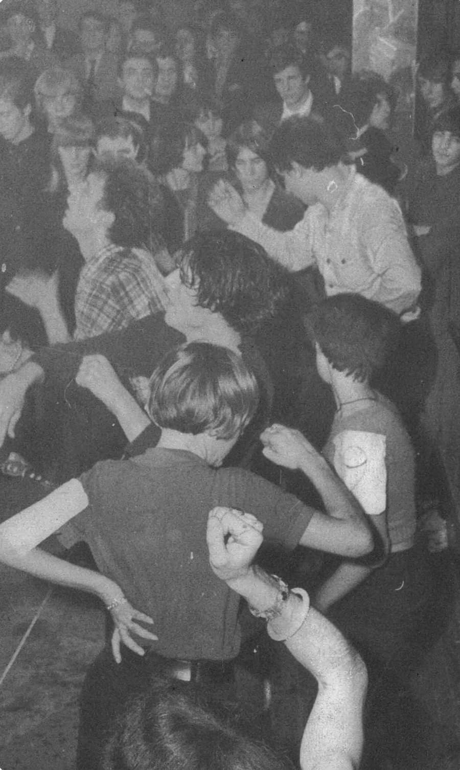 Crowd dancing inside the historic Bus Palladium nightclub in Paris