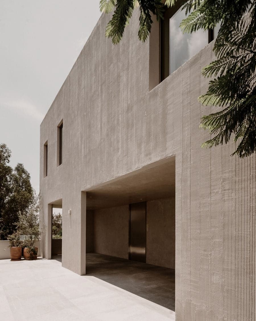 Textured plaster walls and recessed openings defining the upper level of Barrancas House