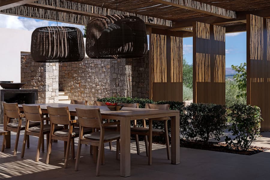 Landscaped courtyard framed by stone walls and Mediterranean planting