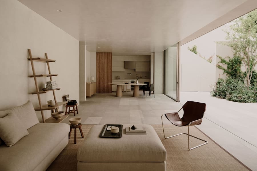 Minimal living room at Barrancas House connected seamlessly with the outdoor terrace