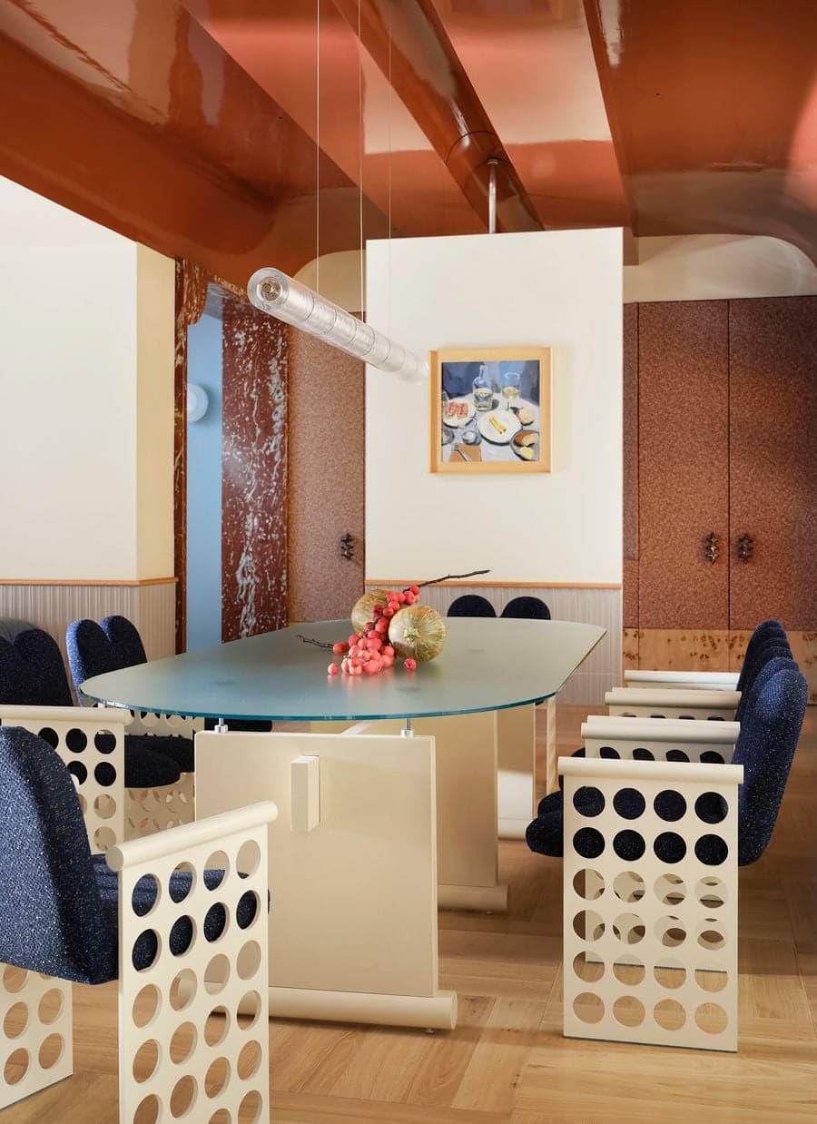 Custom terrazzo kitchen island framed by arched openings inside the renovated 1934 Madrid villa.