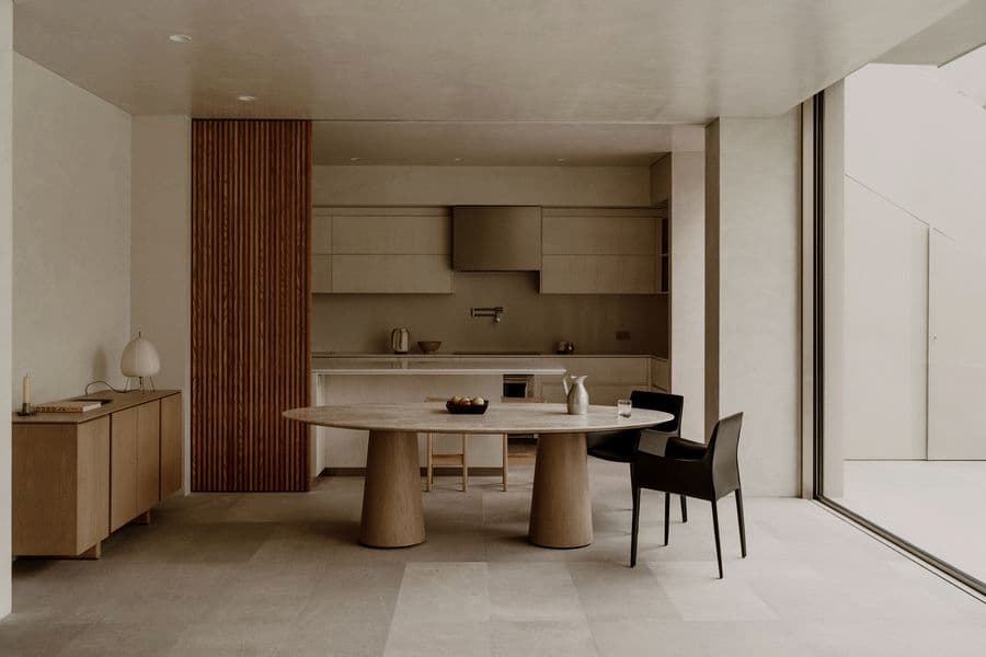 Oval dining table positioned within the open-plan interior of Barrancas House