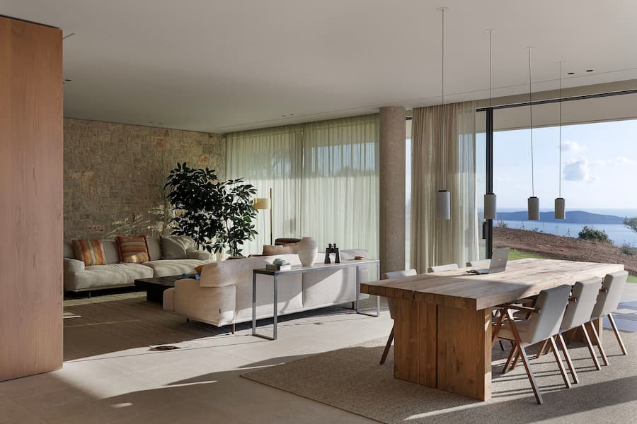 Open-plan living and dining area overlooking Navarino Bay through full-height glazing