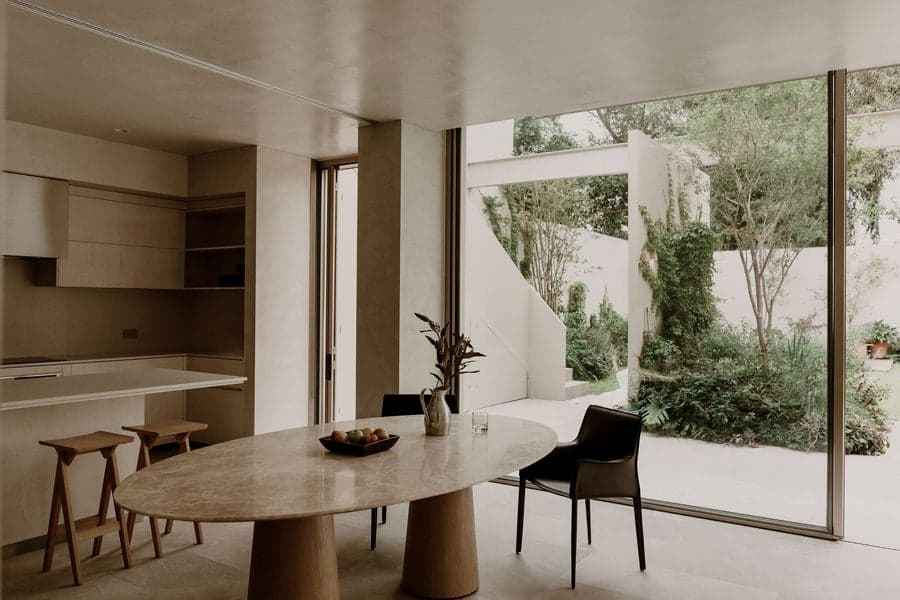 Open-plan kitchen overlooking the garden through full-height sliding glazing