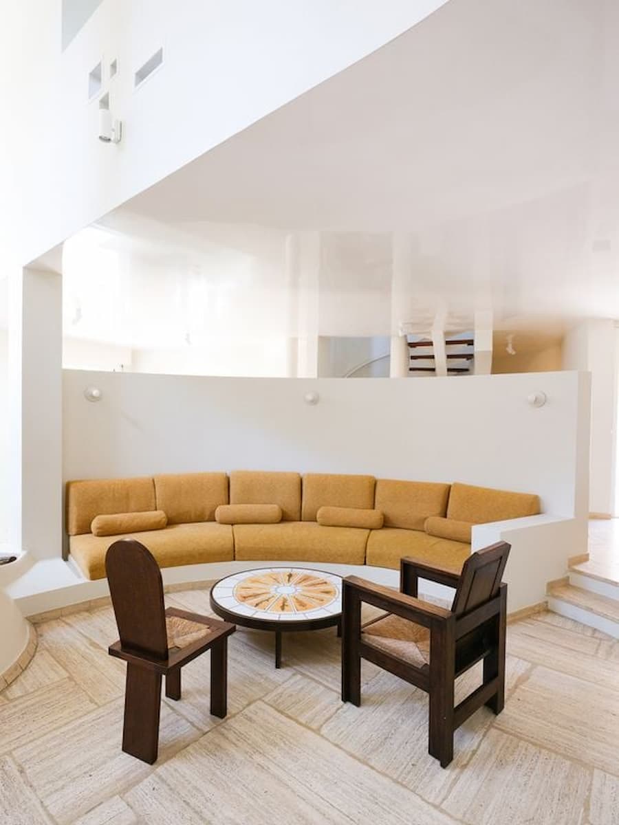 Curved living room at Villa Bank centered around Max Sauze's suspended copper fireplace and collectible furniture