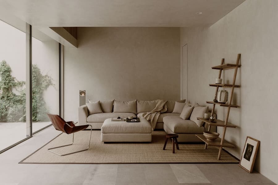 Soft neutral lounge furnished with natural textures and minimalist furniture