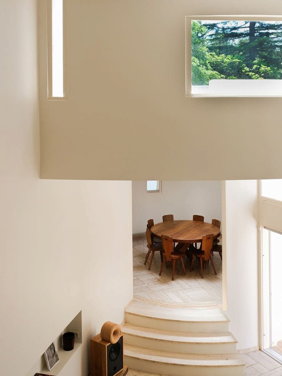 Pierre Chapo dining table positioned beneath sculptural skylights inside Villa Bank at Casa Ideale
