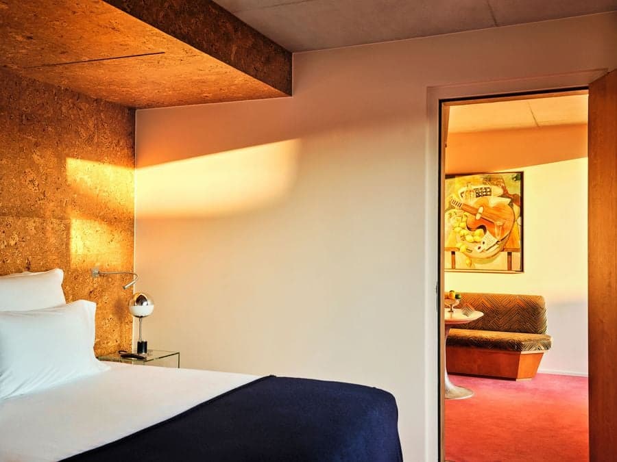 Cork-clad bedroom opening to a private lounge at Bus Palladium Hotel Paris