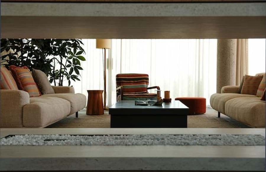 Living room framed through a linear fireplace opening