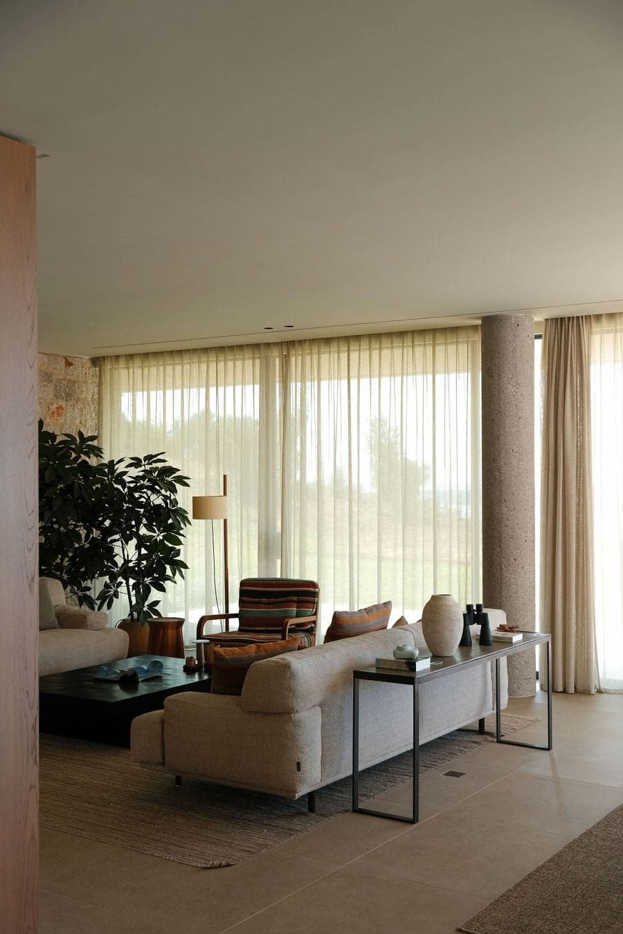 Natural light filtering through sheer curtains into the living room