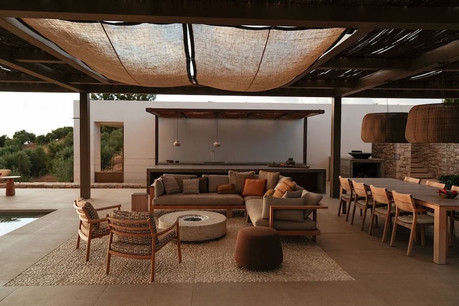 Covered outdoor lounge and dining pavilion with built-in kitchen and shaded seating area
