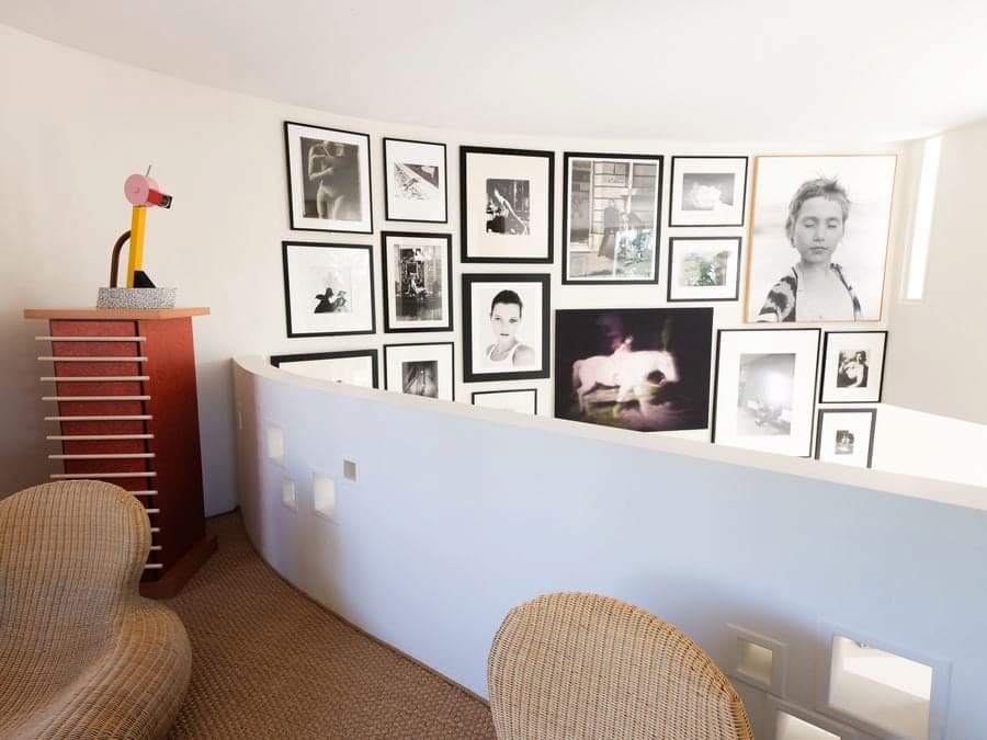 De Sede DS-600 sofa facing Carla Sozzani's photography collection inside the double-height gallery at Casa Ideale