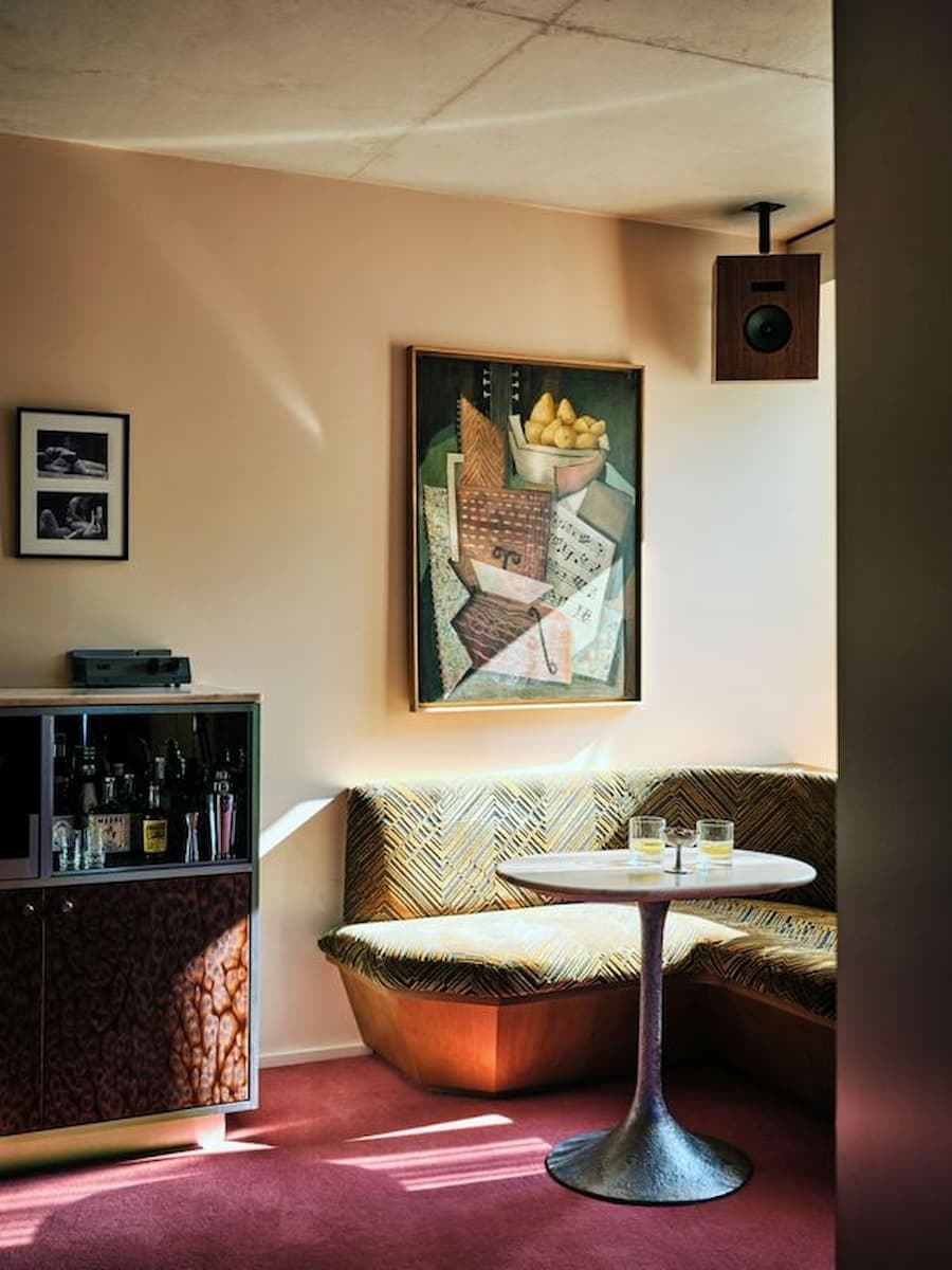 Vintage-inspired lounge with custom bar cabinet inside Bus Palladium Hotel Paris