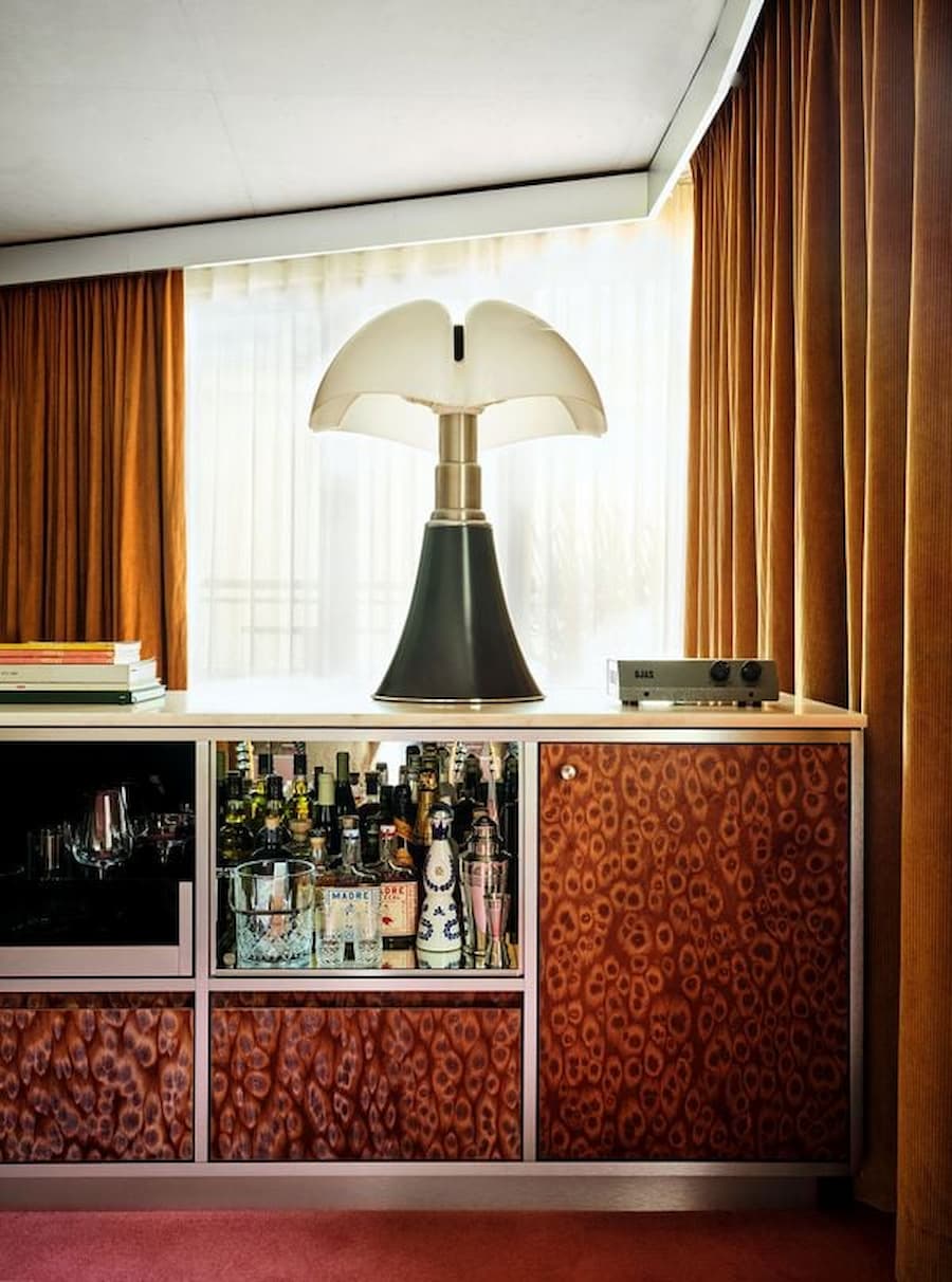 Custom minibar and sculptural table lamp in a Bus Palladium Hotel Paris suite