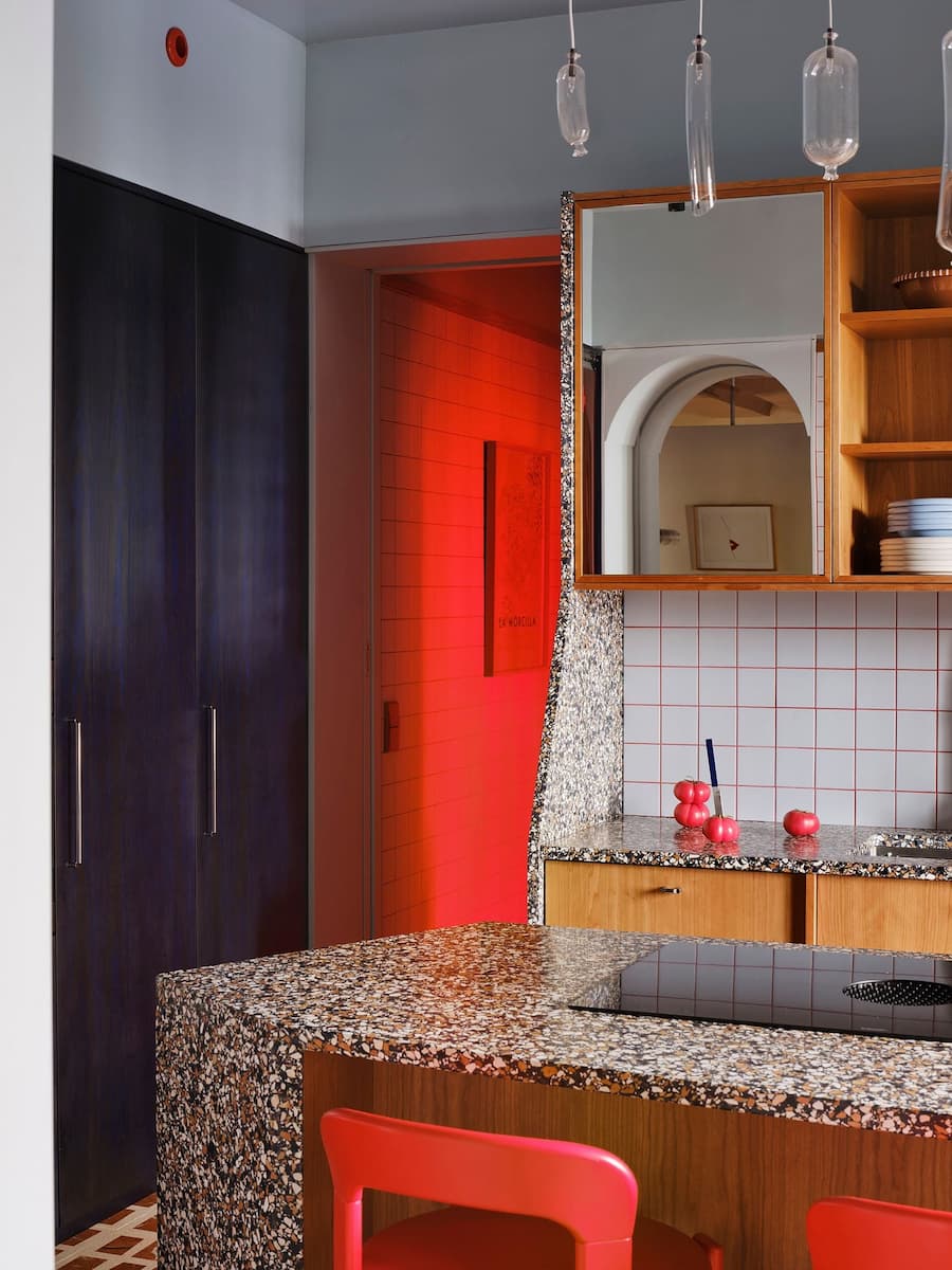 Translucent red vinyl entrance creates a dramatic transition between spaces inside the renovated Madrid residence.