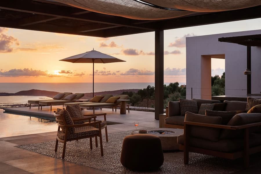 Mediterranean sunset reflected across the infinity pool overlooking Navarino Bay
