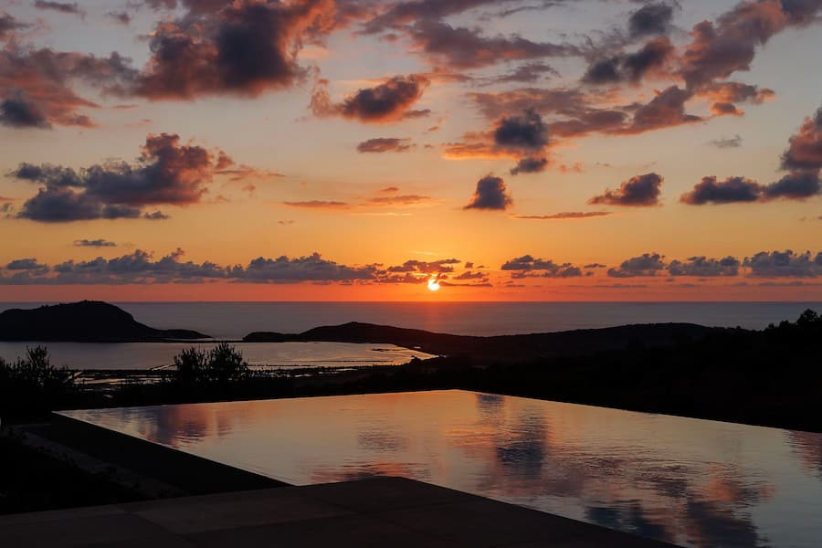 Golden sunset over Navarino Bay with dramatic clouds and coastal landscape