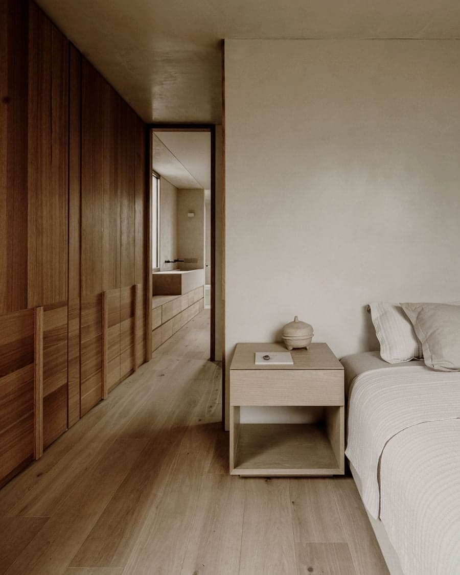 Bedroom perspective highlighting custom wardrobes and integrated bedside furniture