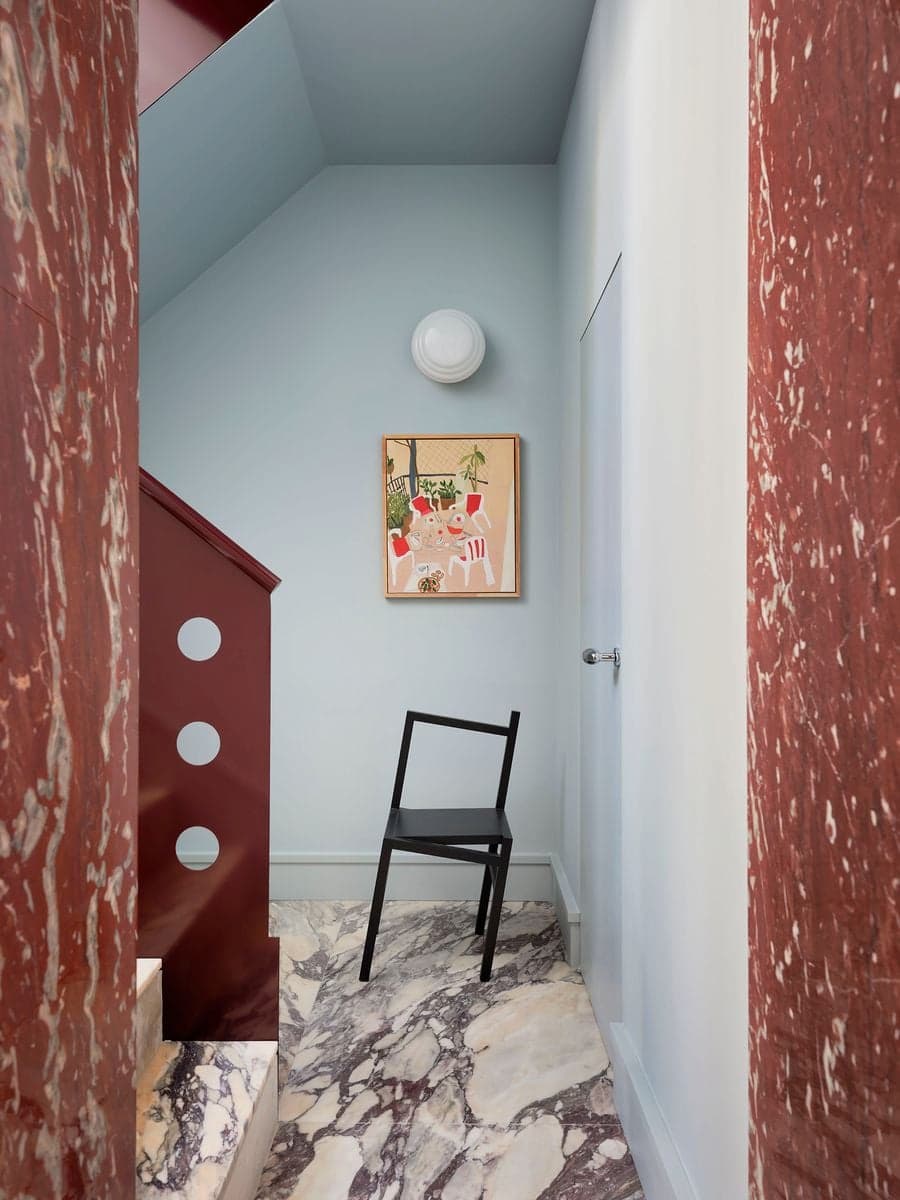Marble staircase landing combines sculptural architecture, natural light and expressive material detailing.