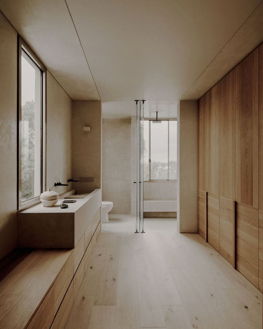 Minimal bathroom suite connecting the vanity, shower and bathtub through a continuous layout