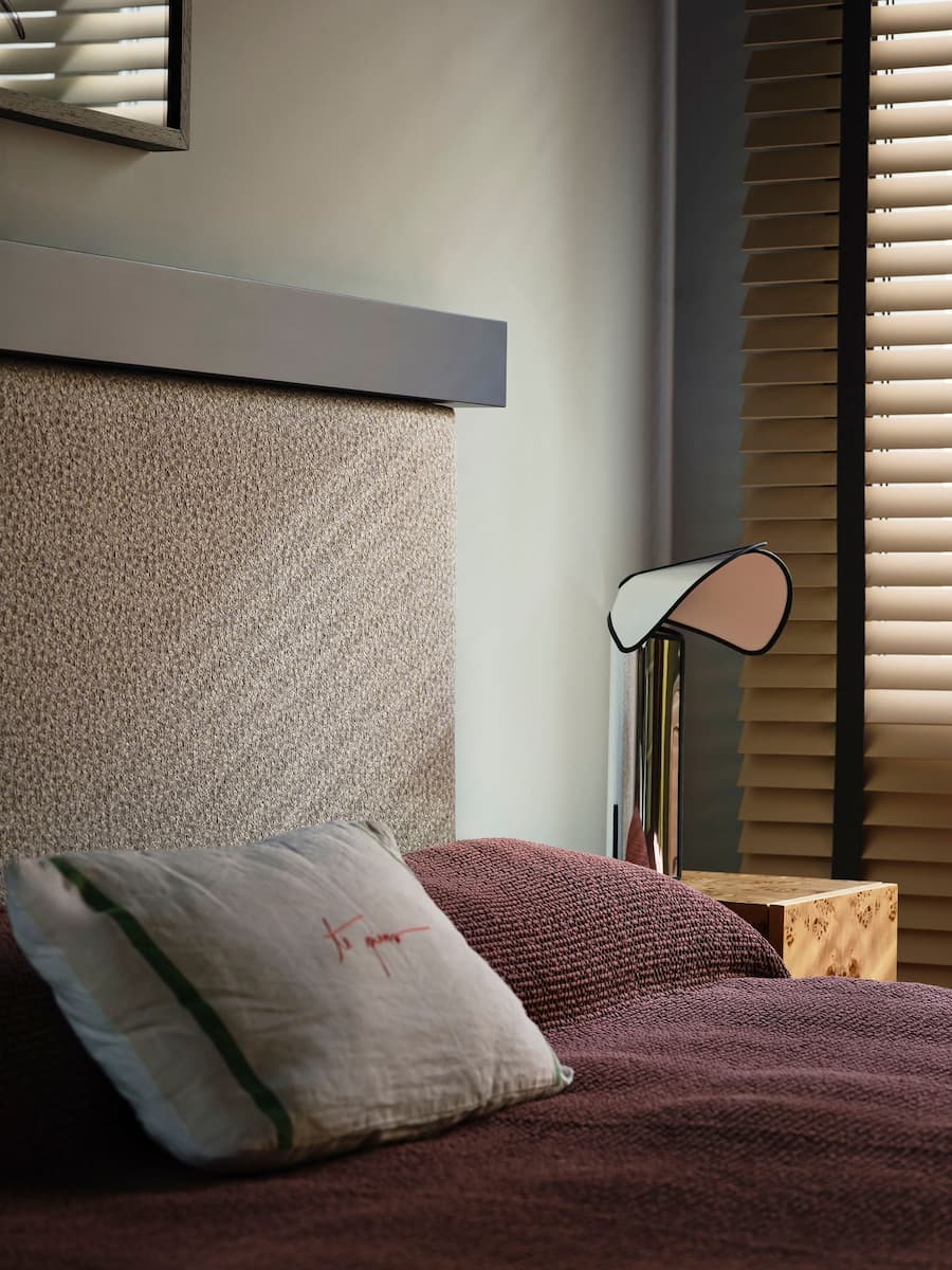 Bedroom detail featuring textured fabrics, custom furniture and soft natural light in the Madrid villa.