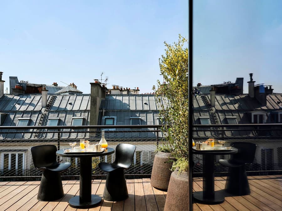 Private terrace overlooking Paris rooftops from a suite at Bus Palladium Hotel