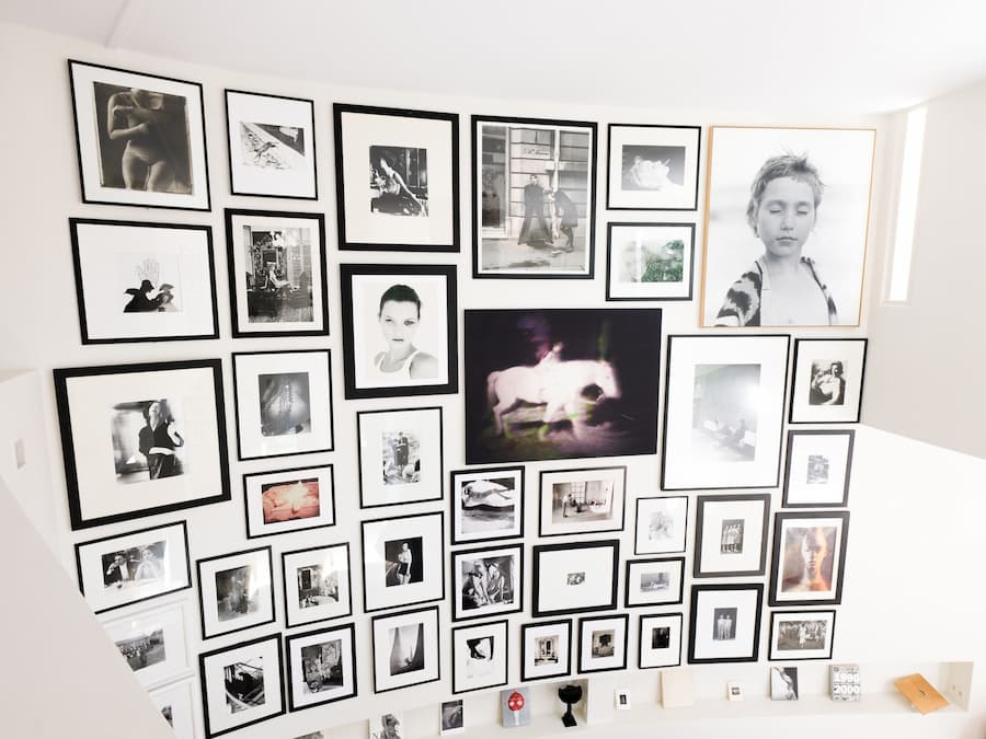 Photography wall from Carla Sozzani's private collection displayed throughout Casa Ideale at Villa Bank