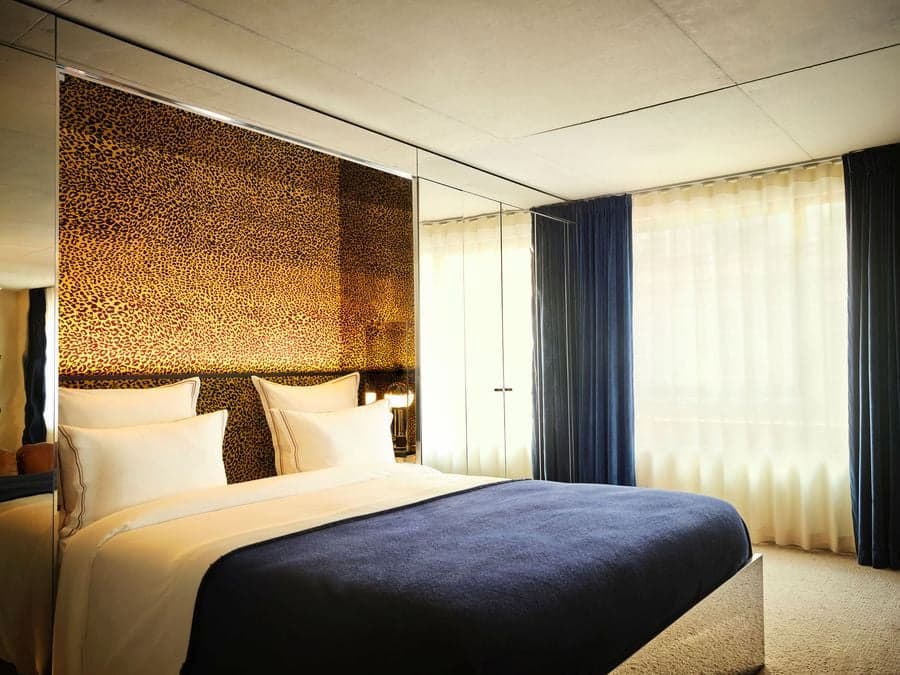 Leopard-print headboard wall adds character to a contemporary Paris hotel suite