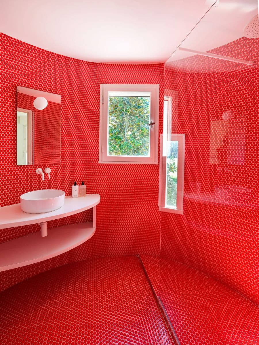 Red mosaic bathroom introducing a bold contemporary contrast inside Casa Ideale at Villa Bank