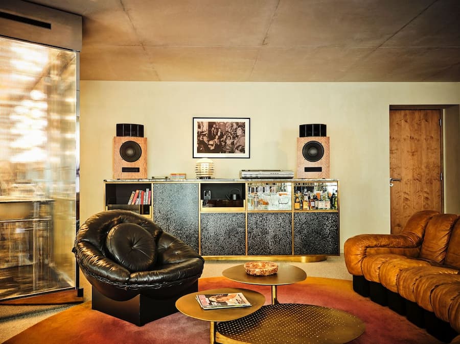 Listening lounge with bespoke bar cabinet and vintage audio speakers at Bus Palladium Hotel