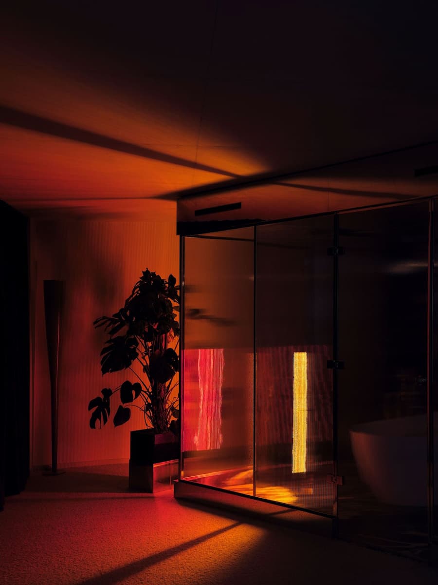 Atmospheric evening lighting transforms the hotel suite into an intimate retreat