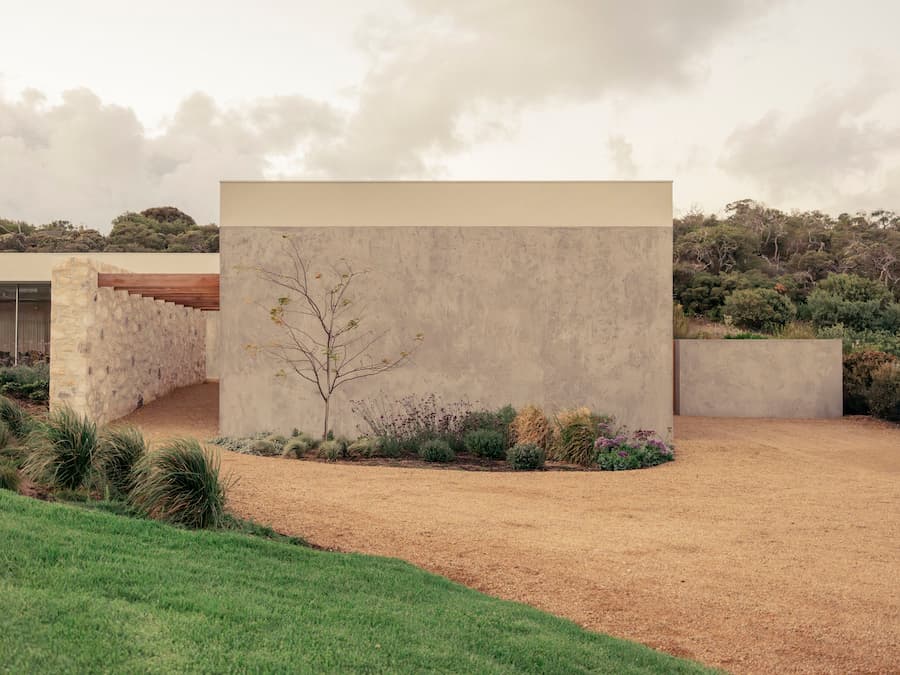 Coastal garden and limestone wall shaping the landscape at Wildcoast Residence.