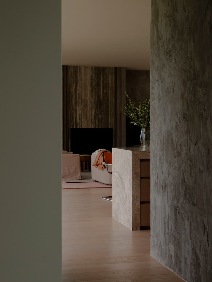 Natural stone kitchen with timber finishes inside Wildcoast Residence.