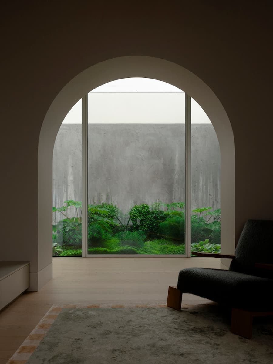 Concrete wall and natural material palette defining the interior of Wildcoast Residence.